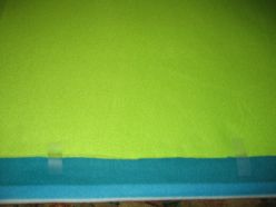 Fold the fabrics up about an inch and a half and tape along one side. Cut until you reach the top (solid green).